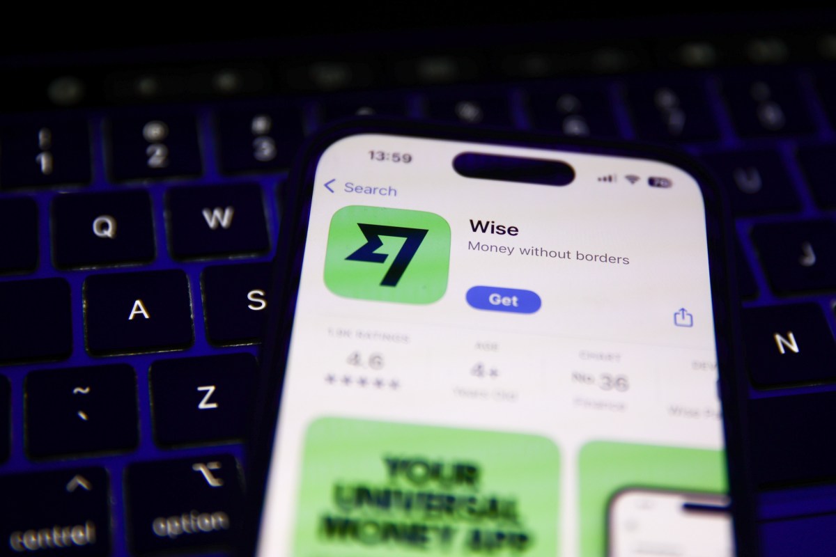 CFPB-fines-fintech-Wise-alleging-it-charged-deceptive-fees.jpg A laptop keyboard and Wise on App Store displayed on a phone screen.