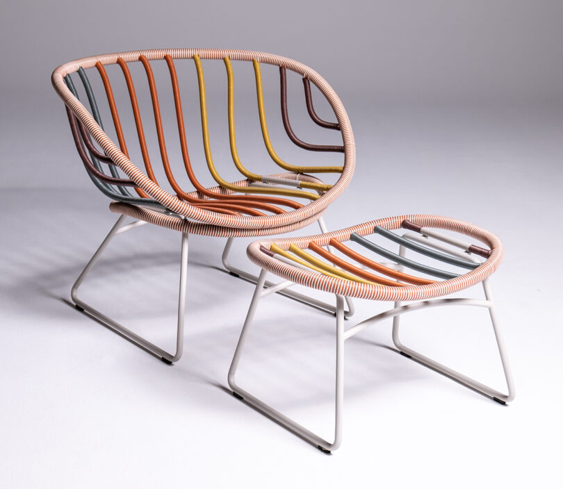 A modern chair with a matching footrest, both featuring multicolored tubular frames and white metal legs, placed on a plain white background.