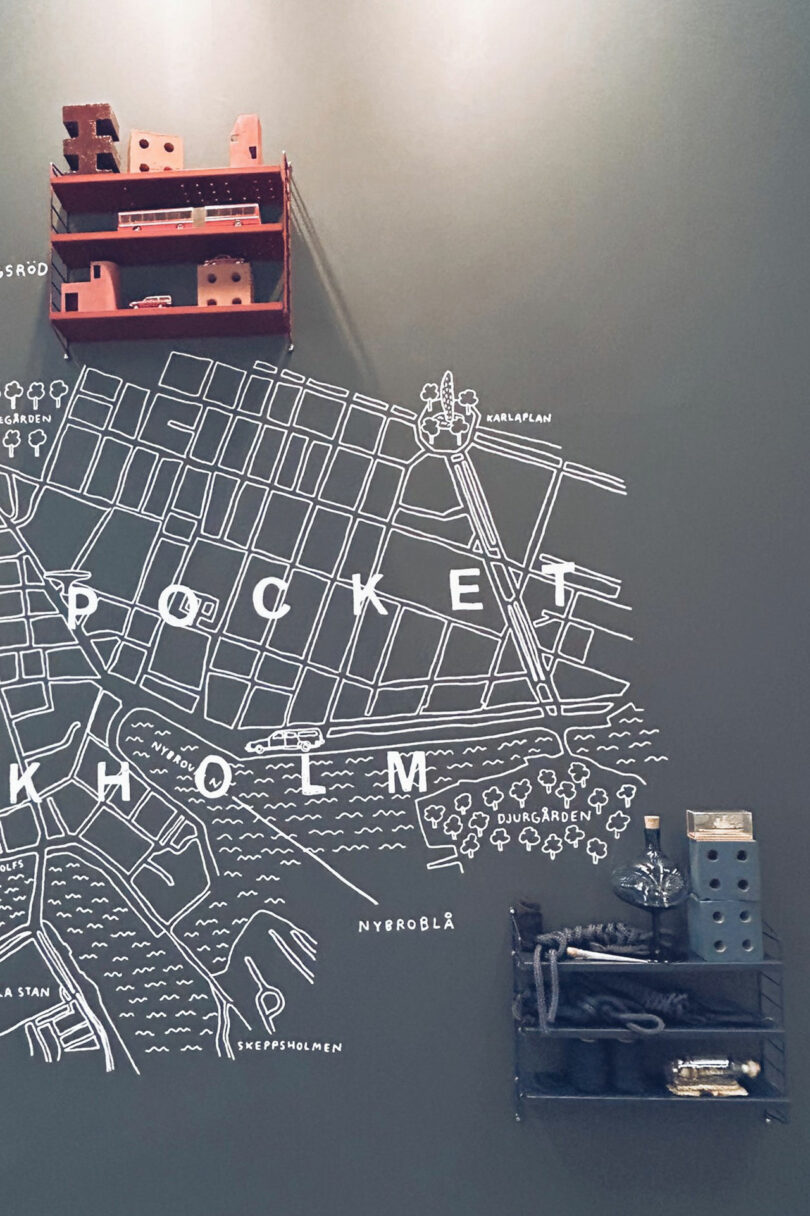 Wall art featuring a white line map with 