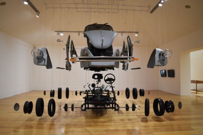 A sculpture consisting of every part of a VW bug dismantled from it and suspended from the ceiling. 