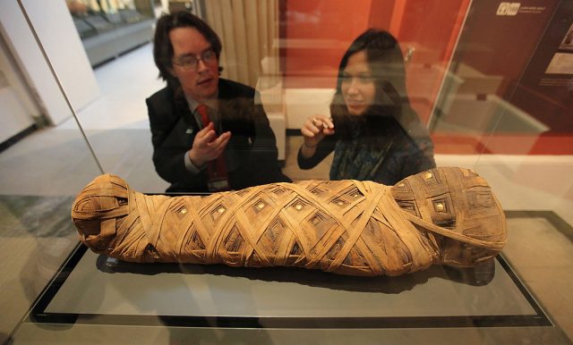 OXFORD, ENGLAND - NOVEMBER 23:  Members of the public view a mummified child dating from 80AD in the Ashmolean Museum's new exhibition of artifacts from ancient Egypt and Nubia on November 23, 2011 in Oxford, England. The new gallery displays for the first time in decades some of the finest Egyptian and Nubian artifacts in the UK. The Egyptian collection opens to the public from November 26, 2011.  (Photo by Oli Scarff/Getty Images)