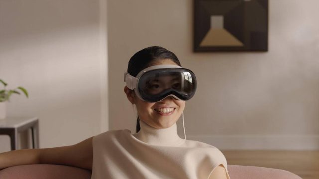Apple-Intelligence-could-arrive-on-Vision-Pro-in-April.jpeg woman wearing Apple Vision Pro headset
