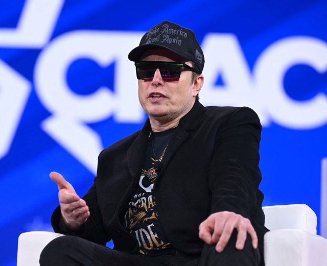 DOGE-has-an-official-acting-administrator-and-its-not-Elon.jpg Elon Musk on stage at CPAC in Maryland with sunglasses on and a MAGA hat
