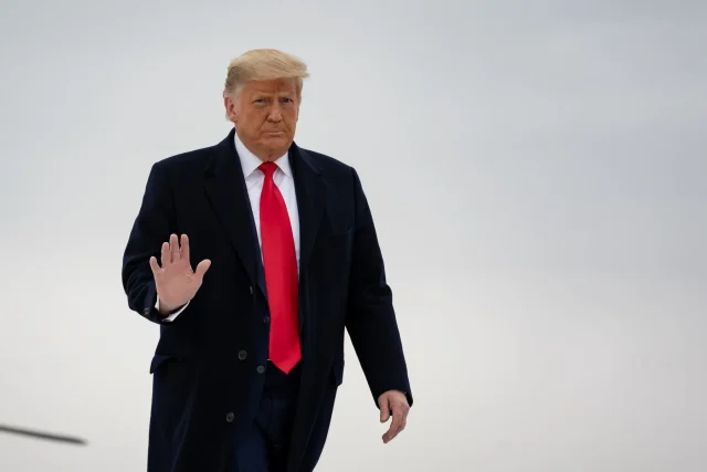 How-Will-the-Trump-Administration-Impact-Travel.jpeg An elderly man with a red tie waves