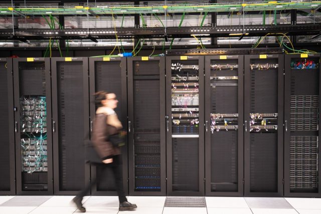 Investments-in-French-AI-ecosystem-reach-85B-as-Brookfield-commits.jpg A visitor walks past a computer bay at the PA10 data center, operated by Equinix Inc., in Paris, France.