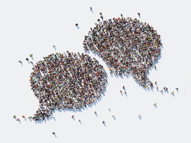 MLCommons-and-Hugging-Face-team-up-to-release-massive-speech.jpg Human crowd forming a big speech bubble on white background; using