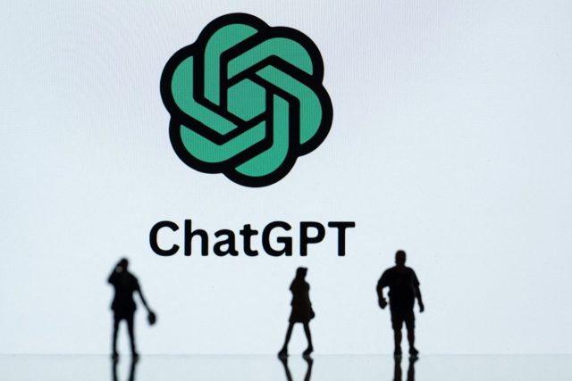 OpenAI-removes-certain-content-warnings-from-ChatGPT.jpg This photograph taken in Mulhouse, eastern France on October 19, 2023, shows figurines next to the ChatGPT logo. (Photo by SEBASTIEN BOZON/AFP via Getty Images)