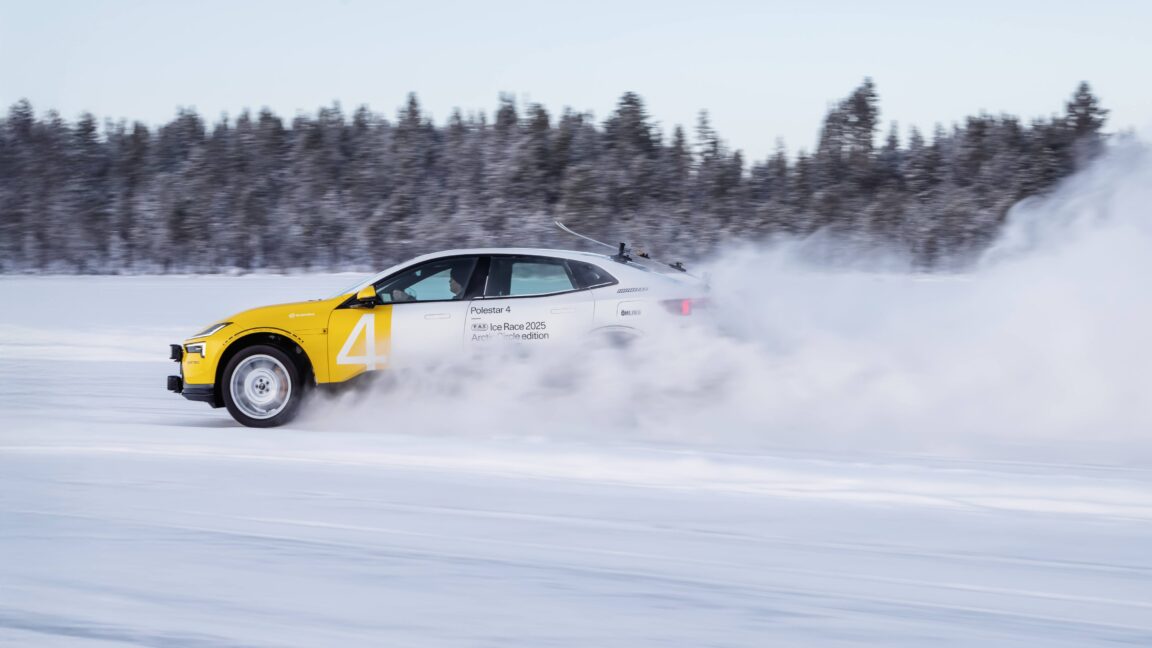 A polestar 4 with yellow and white paint and some skis on the back