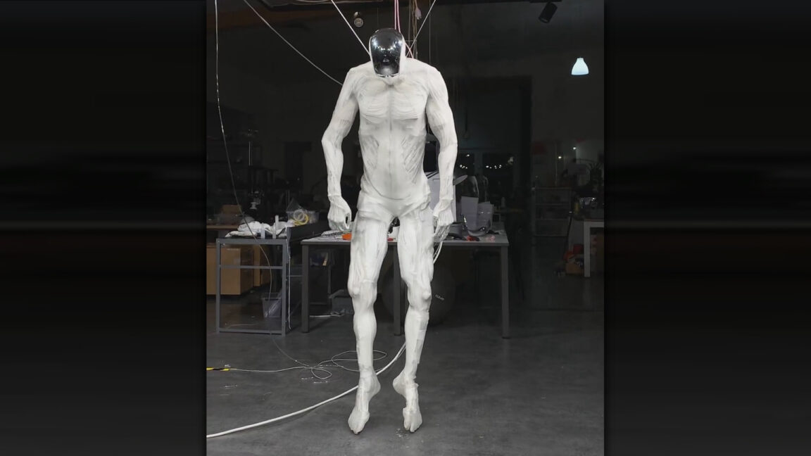 Robot-with-1000-muscles-twitches-like-human-while-dangling-from.jpg A still frame from a Clone Robotics Protoclone robot demo.