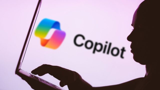Thousands-of-exposed-GitHub-repos-now-private-can-still-be.jpg In this photo illustration, the Microsoft Copilot logo is seen in the background next to a silhouette of a person using a notebook.