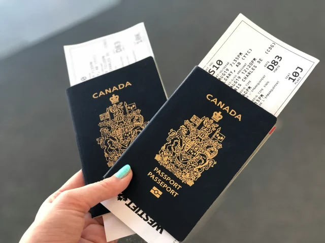 Trumps-Potential-Trade-War-With-Canada-Tourism-at-Risk.jpg Two Canadian passports pictured at the airport.