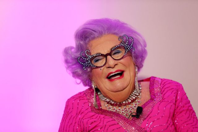 Uproar-over-Australias-move-to-drop-Venice-Biennale-Artist.jpg A smiling man in a pink wig and dress.