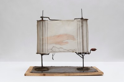 A sculpture resembling a scroll with a hand painted onto its translucent paper.