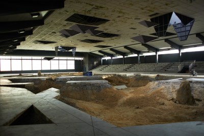 A skating rink with parts of its floor dug out.
