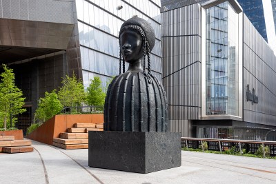 A sculpture of an eyeless woman whose neck leads to a dome-shaped body.
