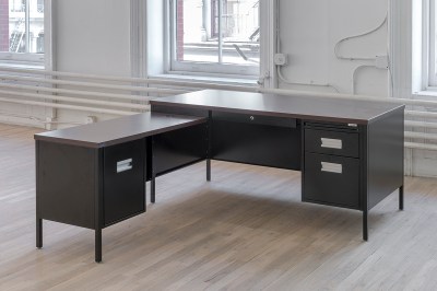 A desk shown in a gallery.