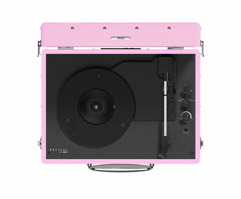 The Pink Mixx portable record player, with its open lid revealing the turntable, tonearm, and control knobs, effortlessly combines style and function for vinyl enthusiasts.