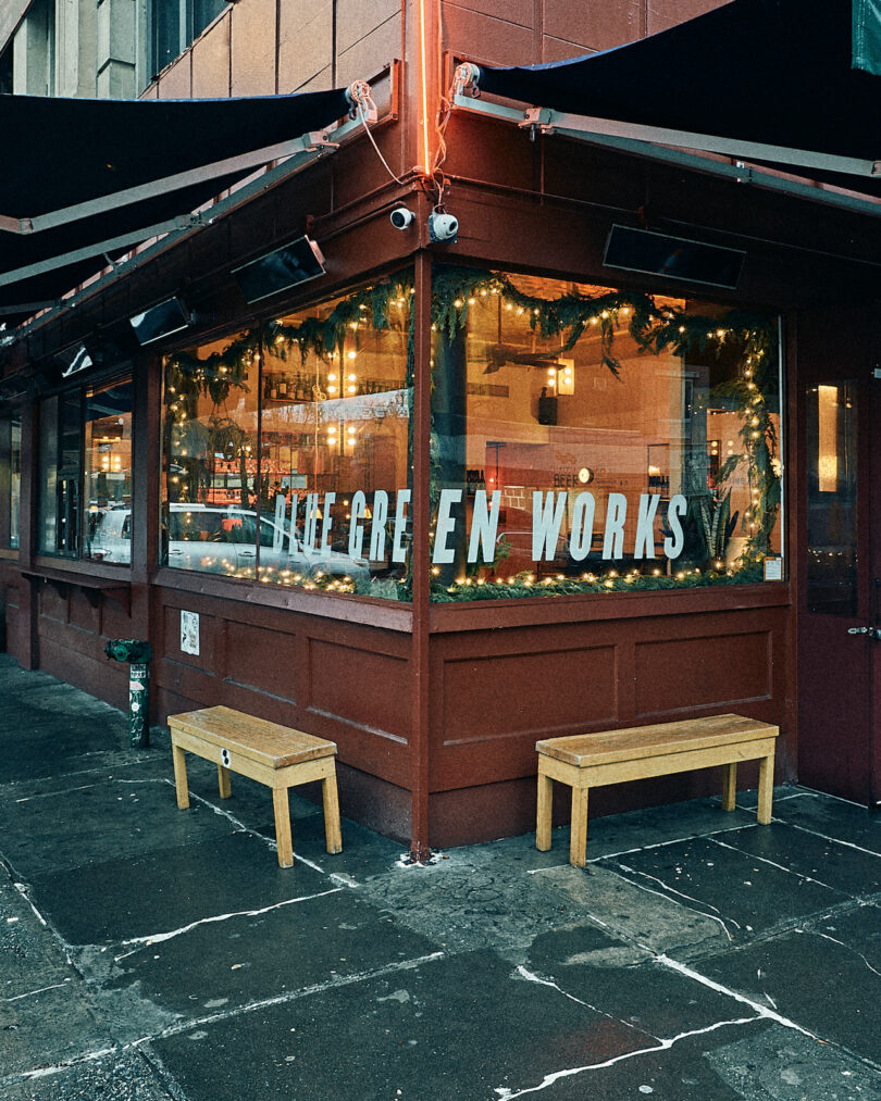 A corner cafe with large windows reading 