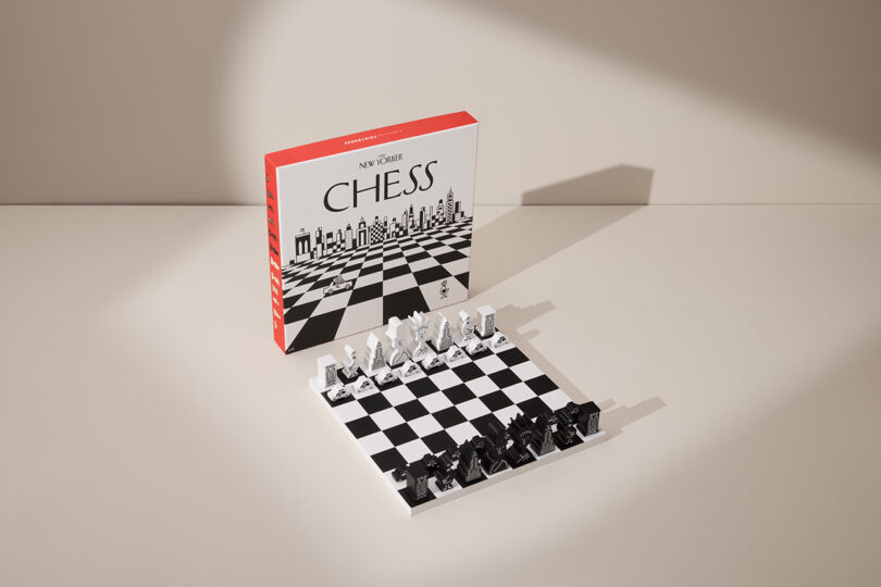 Chess set with box. White and black pieces arranged on the board, ready for play. Box displays 