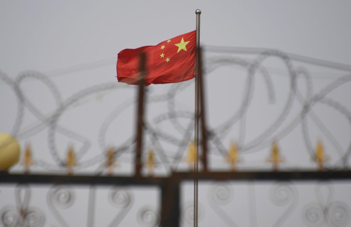 1743039544_Leaked-data-exposes-a-Chinese-AI-censorship-machine.jpg Chinese flag on pole behind razor wire
