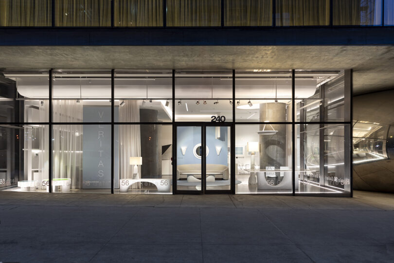 Storefront with large windows displaying modern furniture and lighting. The number 