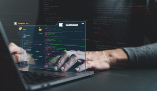 AI-coding-assistant-Cursor-reportedly-tells-a-vibe-coder-to.jpg Software developer coding with code coming out of laptop in futuristic looking way.
