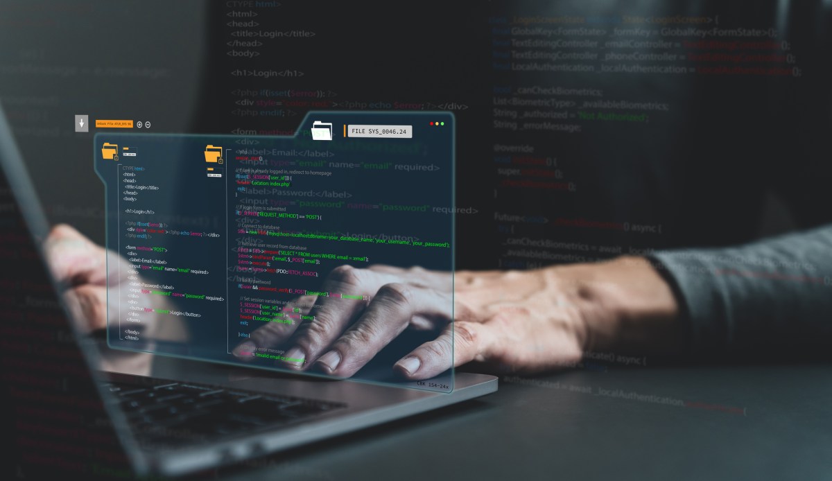 AI-coding-assistant-Cursor-reportedly-tells-a-vibe-coder-to.jpg Software developer coding with code coming out of laptop in futuristic looking way.