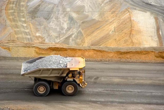 Earth-AIs-algorithms-found-critical-minerals-in-places-everyone-else.jpeg A large yellow dump truck carries ore out of a pit mine.