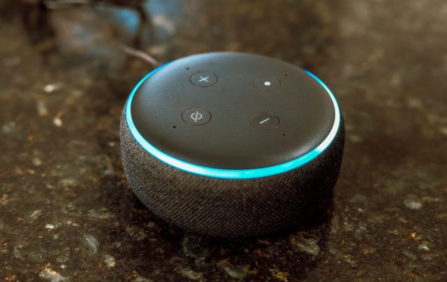 Everything-you-say-to-your-Echo-will-be-sent-to.jpg In this photo illustration, Echo Dot smart speaker with working Alexa with blue light ring seen displayed.