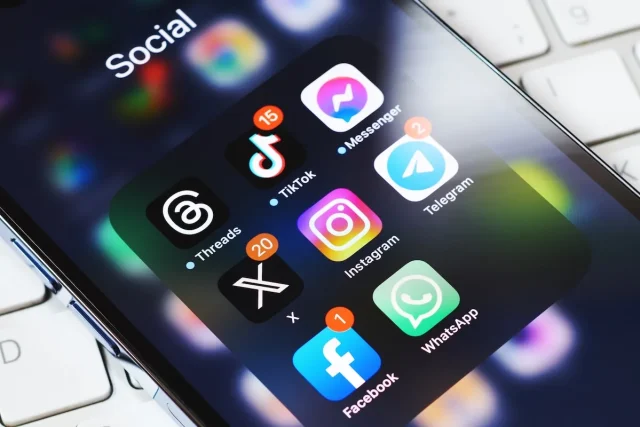 How-Social-Media-Is-Shaping-Travel-Planning-and-Booking.jpeg Social media apps on smartphone screen.