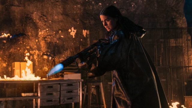 John-Wick-has-a-new-target-in-latest-Ballerina-trailer.jpg youn woman holding a flame thrower with a determined expression