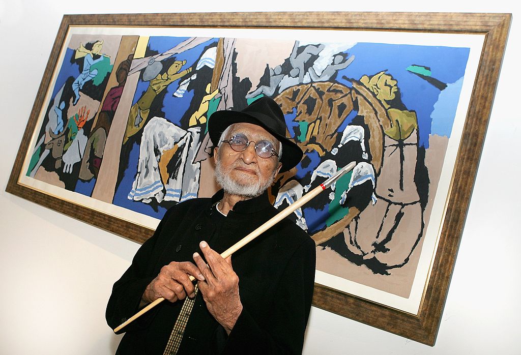 MF-Husain-Painting-Makes-Auction-History-Morning-Links.jpg A man with a white beard in front of a painting.