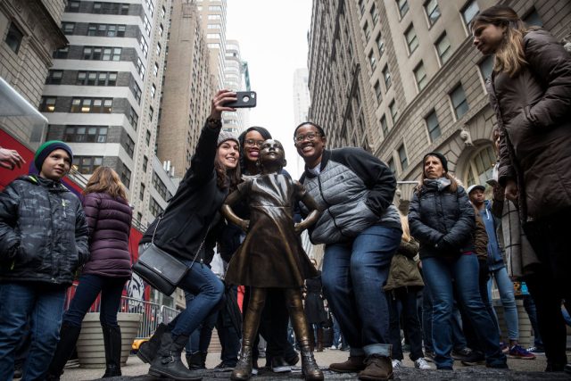 National-Endowment-for-the-Arts-Scraps-Challenge-America-Grant-Program.jpg People pose next to a bronze sculpture.