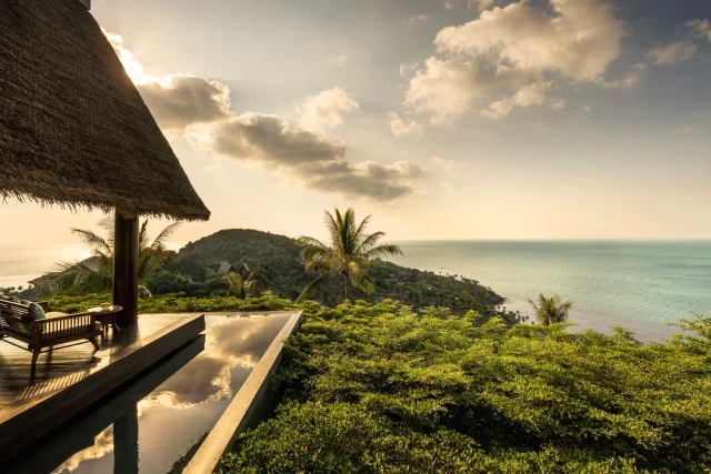 The-White-Lotus-Effect-Could-Be-a-Disaster-for-Thailands.jpeg View of green forests and a sea from a hotel patio