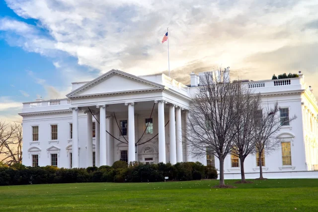 Trumps-Next-US-Travel-Ban-May-Target-Dozens-of-Countries.jpeg View of a Georgian-styled pillared white two-storey building.