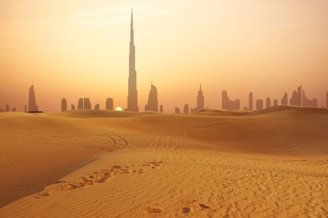 Who-Saw-The-Most-Growth.jpeg An image of Dubai with desert in the foreground.