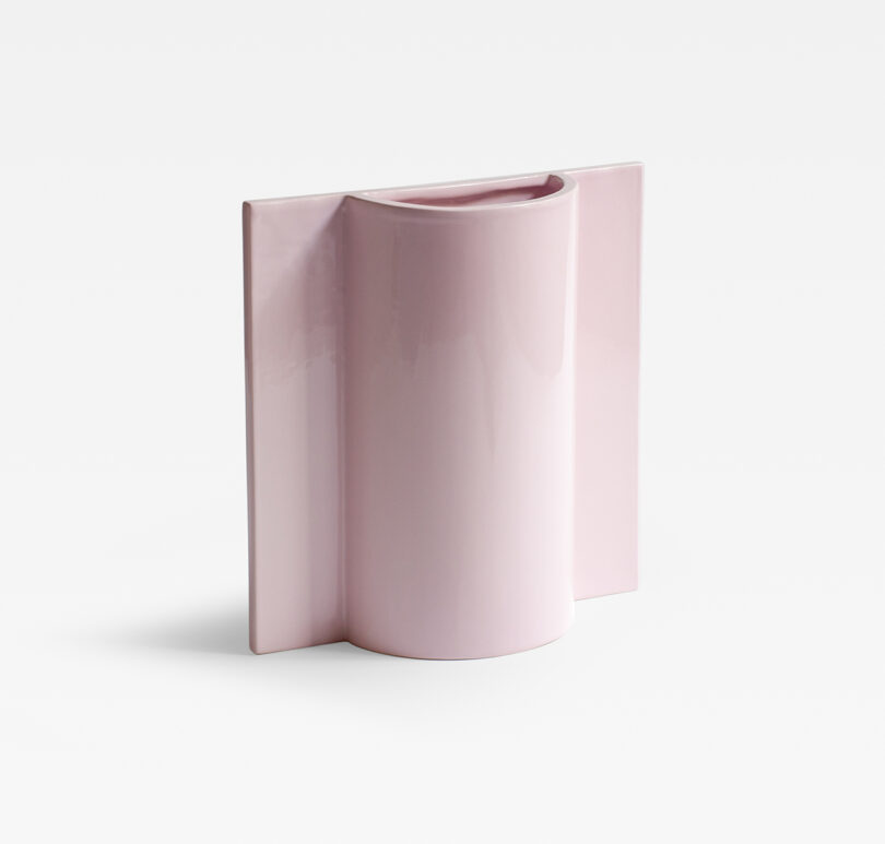 A pink ceramic vase with a modern, rectangular, flat-backed design.