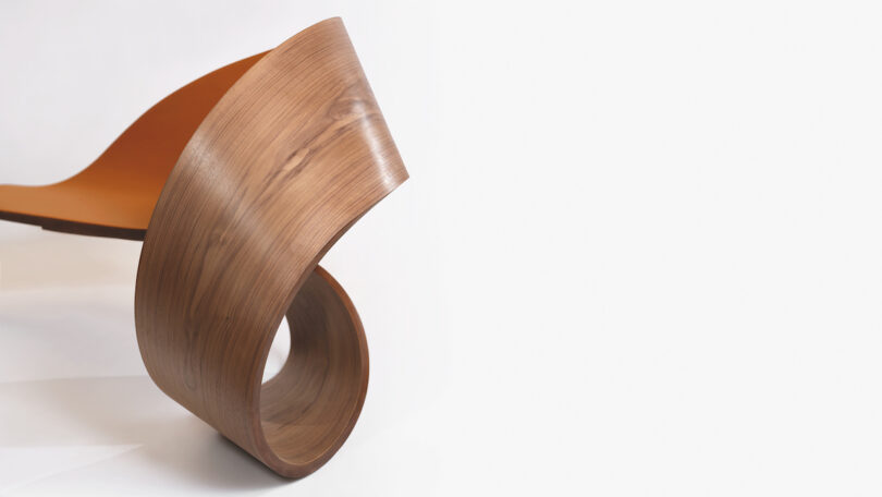 A modern, curved wooden bench with a spiral base against a plain white background.