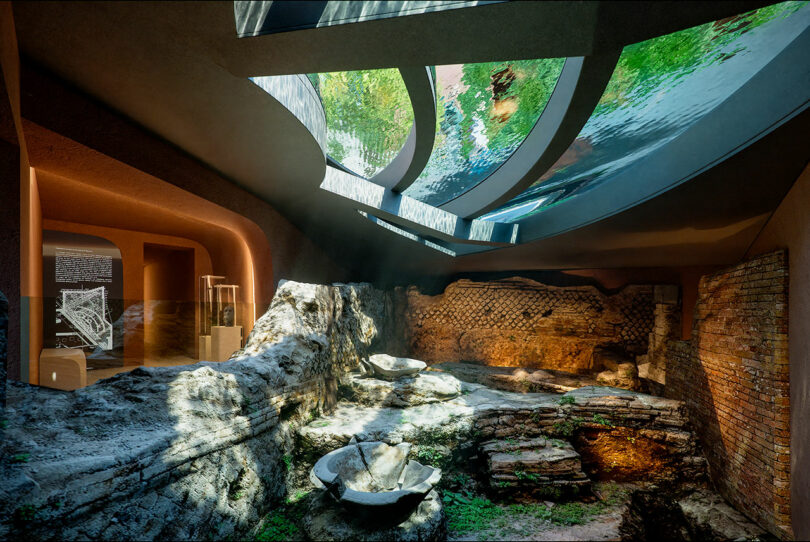 Interior of an archaeological museum with exposed ancient ruins, modern architecture, and skylights casting natural light on the site.