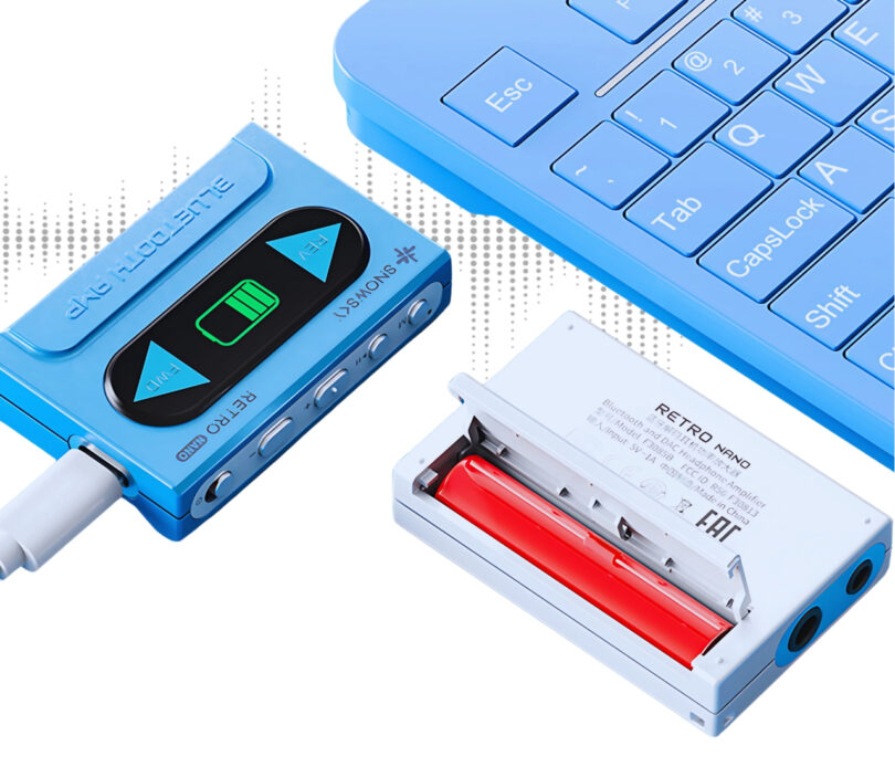 Blue digital audio player, cassette tape adapter connected, with a blue keyboard and open cassette showing inside components.