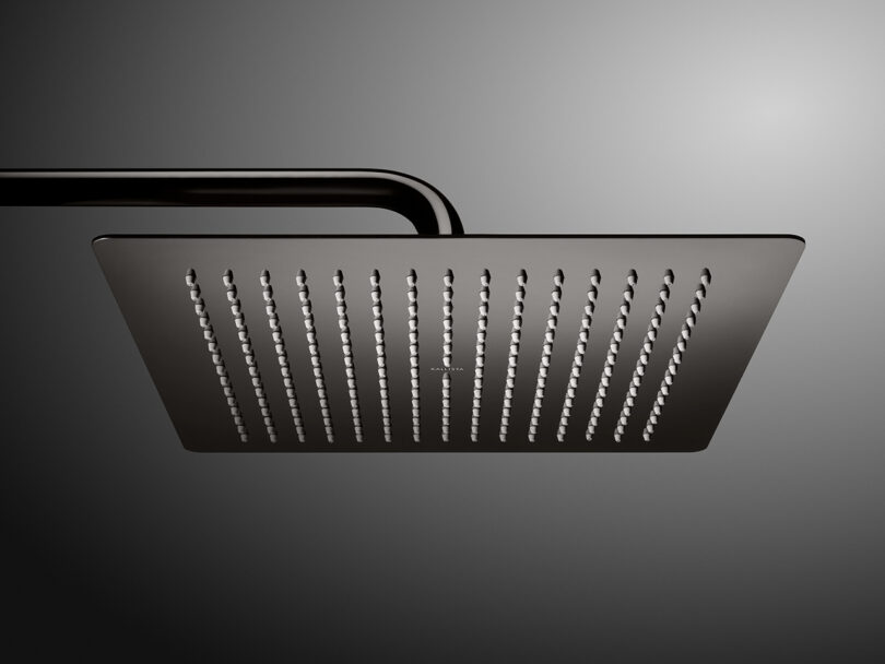A square, modern overhead showerhead with multiple small water nozzles, attached to a curved pipe, against a gray background.