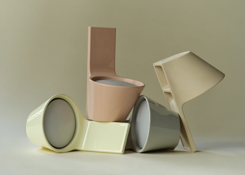 Four uniquely shaped pastel ceramic lights are stacked together against a neutral background