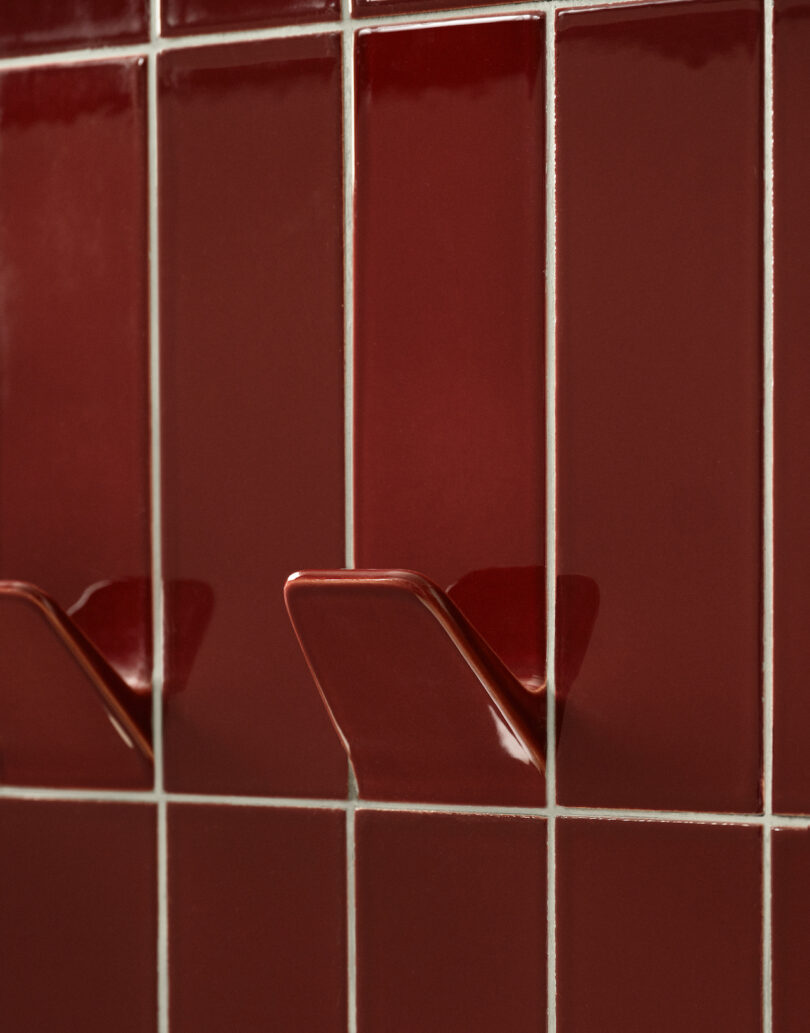 Red bathroom tiles with built-in hooks on the wall