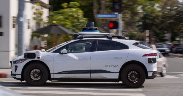 A-Waymo-robotaxi-got-trapped-in-Chick-fil-A-drive-through.jpg A Waymo autonomous vehicle operating on a tree-lined street in Santa Monica.