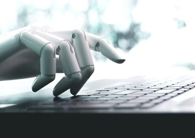 A-nonprofit-is-using-AI-agents-to-raise-money-for.jpg Robot concept or robot hand chatbot pressing computer keyboard enter