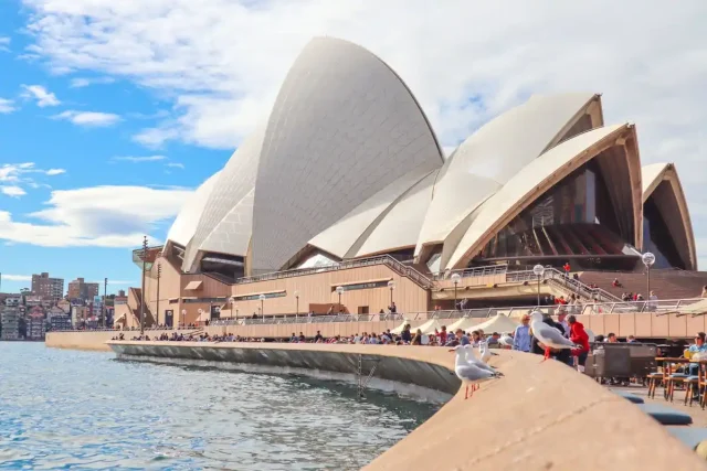 Australias-Mantra-for-Winning-Indian-Tourists-Easiest-Visa-Process.jpg Tourists gathered outside Sydney Opera House in Australia.