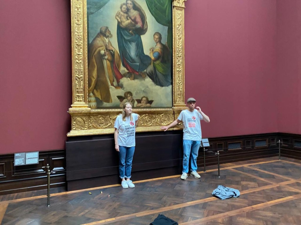 Climate-Protesters-Pardoned-after-Gluing-Hands-to-Raphael-Painting.jpg Climate Protesters Pardoned after Gluing Hands to Raphael Painting