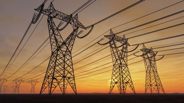 Former-Tesla-exec-Drew-Baglinos-new-startup-is-rethinking-the.jpeg Power lines loom on the horizon at sunset.