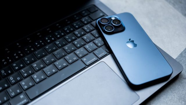 France-fines-Apple-E150M-for-excessive-pop-ups-that-let-users.jpg An iPhone lies face-down on top of a MacBook Pro.