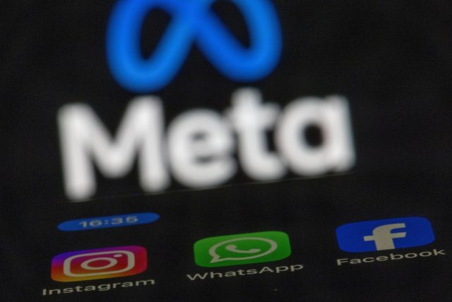 Meta-to-start-training-its-AI-models-on-public-content.jpg The apps Instagram, Facebook and WhatsApp can be seen on the display of a smartphone in front of the logo of the Meta internet company.